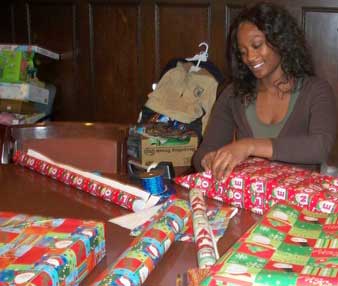 Writing tutor Brittany Mullings wraps presents for the family
